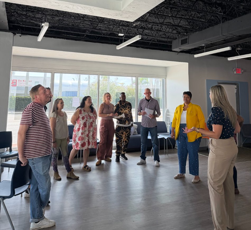 Team standing together in a circle during a relationship-building exercise