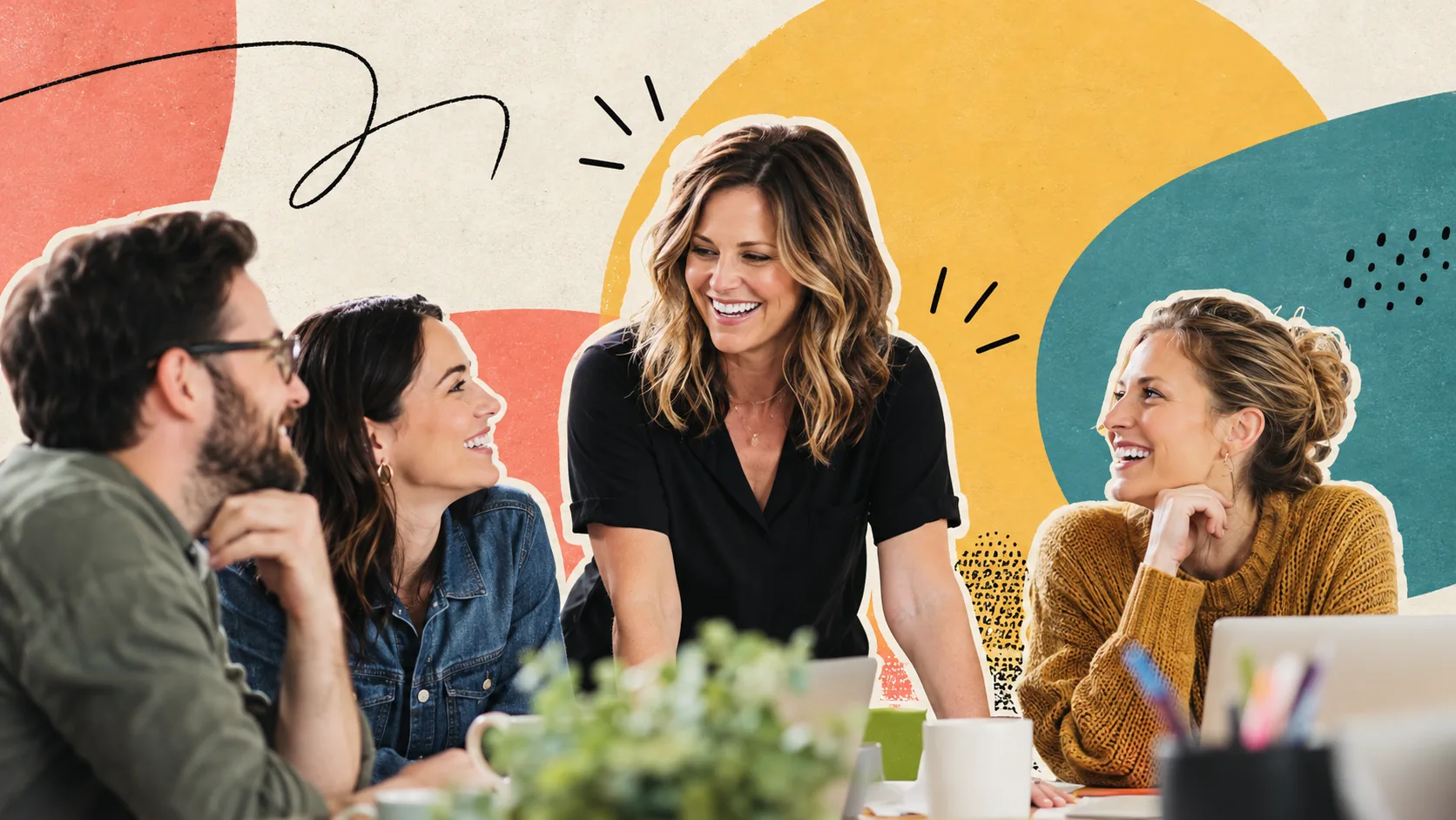 Nicole Meyer laughing with three colleagues around a work table during a relaxed team conversation
